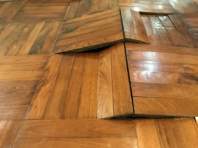 Oak parquet floor buckling after water soaked in from below